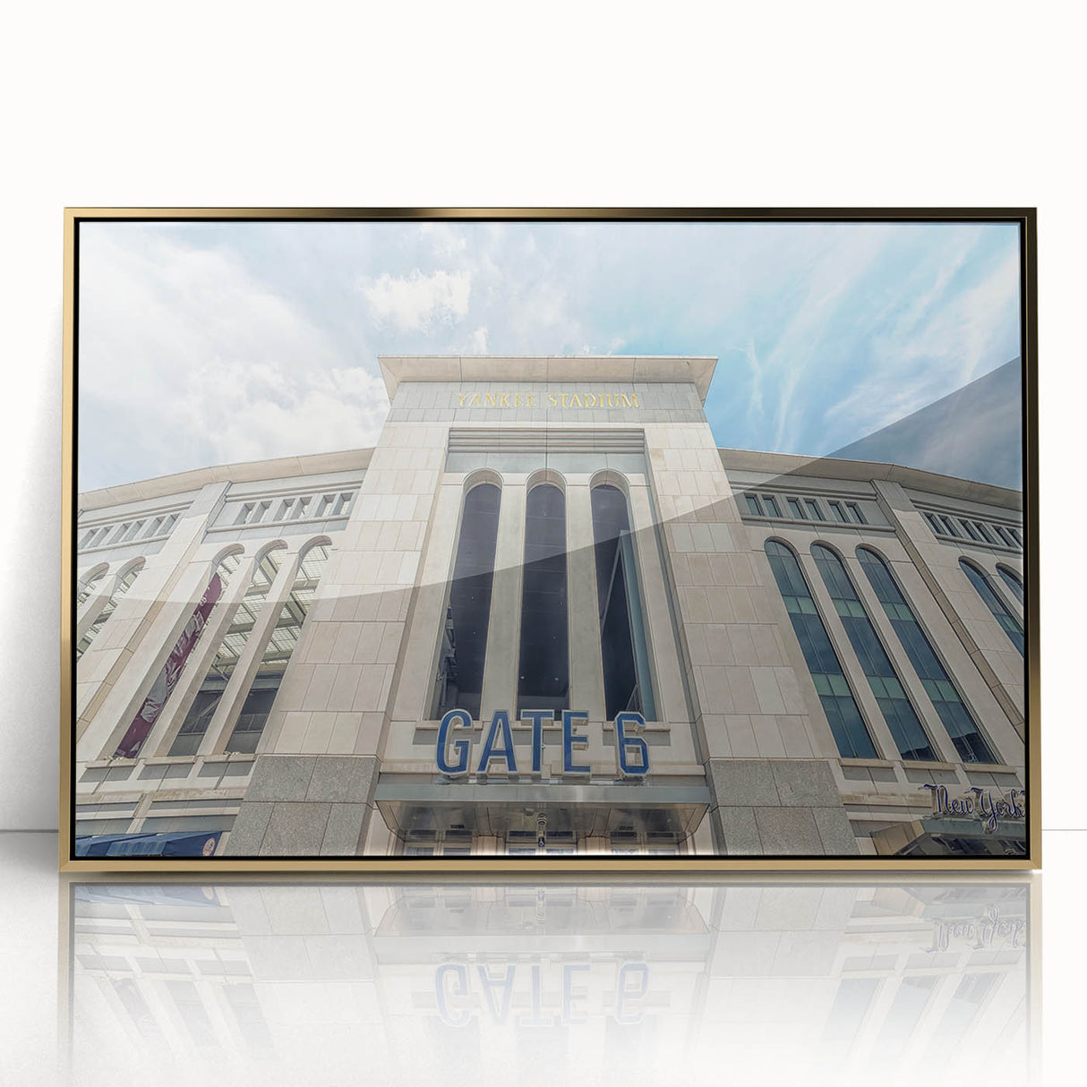 Large acrylic print of the New York City skyline in gold tones, framed, in a mid-century modernist style.