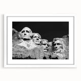 Abstract art print of Mt. Rushmore in muted earth tones on a white framed poster, suitable for bedroom or dining room decor.