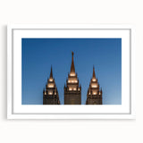 Abstract art print of Salt Lake City with vibrant blue and orange tones on a white framed mat.