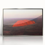 Acrylic print of Ayers Rock in silver frame, featuring earthy red and orange tones, suitable for modern art wall decor.
