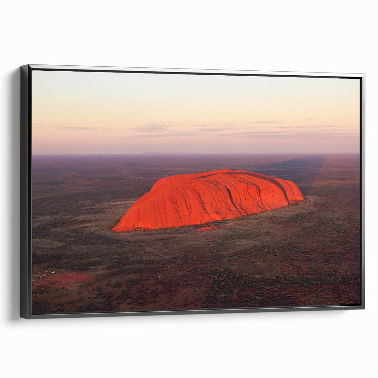Framed canvas featuring a black and white image of Ayers Rock in Australia, ideal for bedroom wall decor.