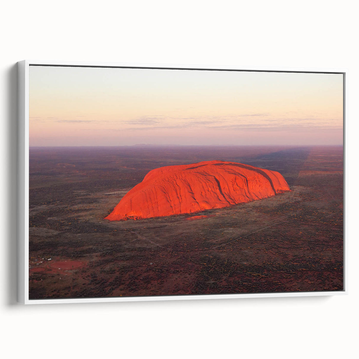 Framed canvas of Ayers Rock in Australia with muted earth tones, ideal for bedroom wall art.
