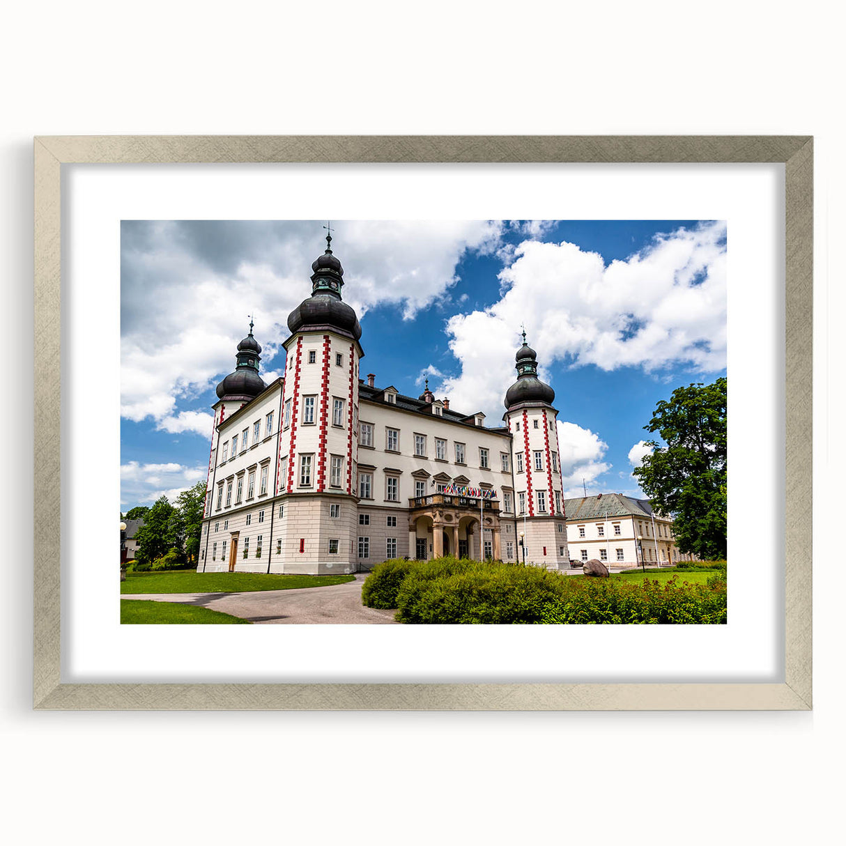 Textured art print featuring an abstract depiction of a European cityscape in muted earth tones, framed in silver.