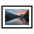 Abstract art print of a colorful, textured landscape with vibrant hues, in a black frame with mat.