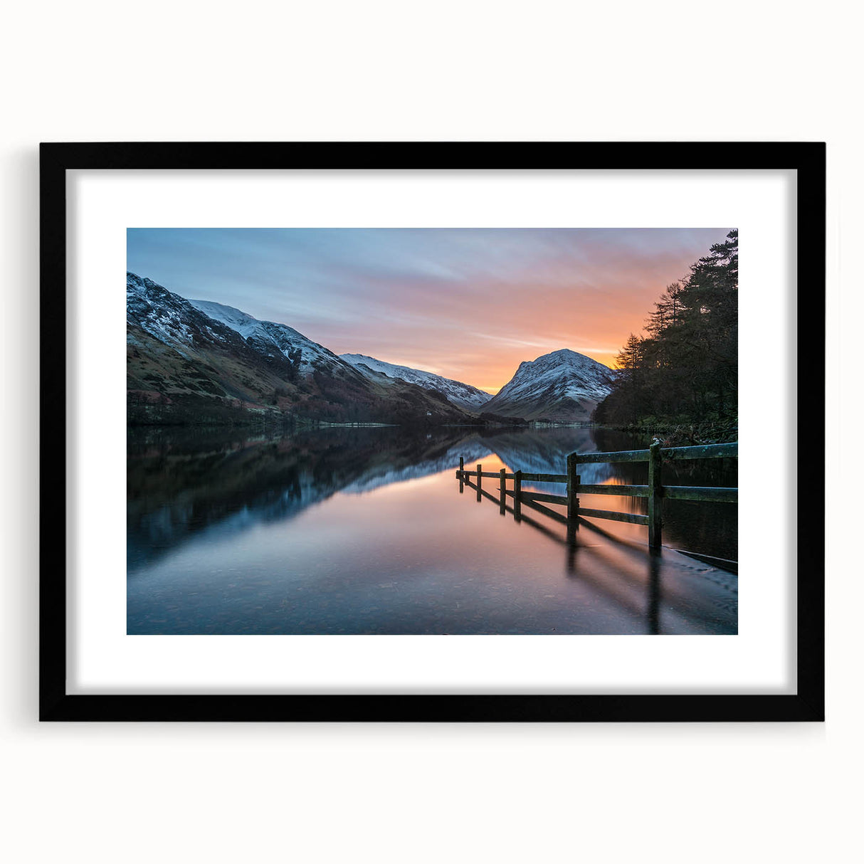 Abstract art print of a colorful, textured landscape with vibrant hues, in a black frame with mat.