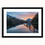 Abstract art print of a colorful, textured landscape with vibrant hues, in a black frame with mat.