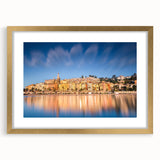 Abstract art print of Monaco scenery in muted gold and blue tones on a framed mat, suitable for dining room decor.