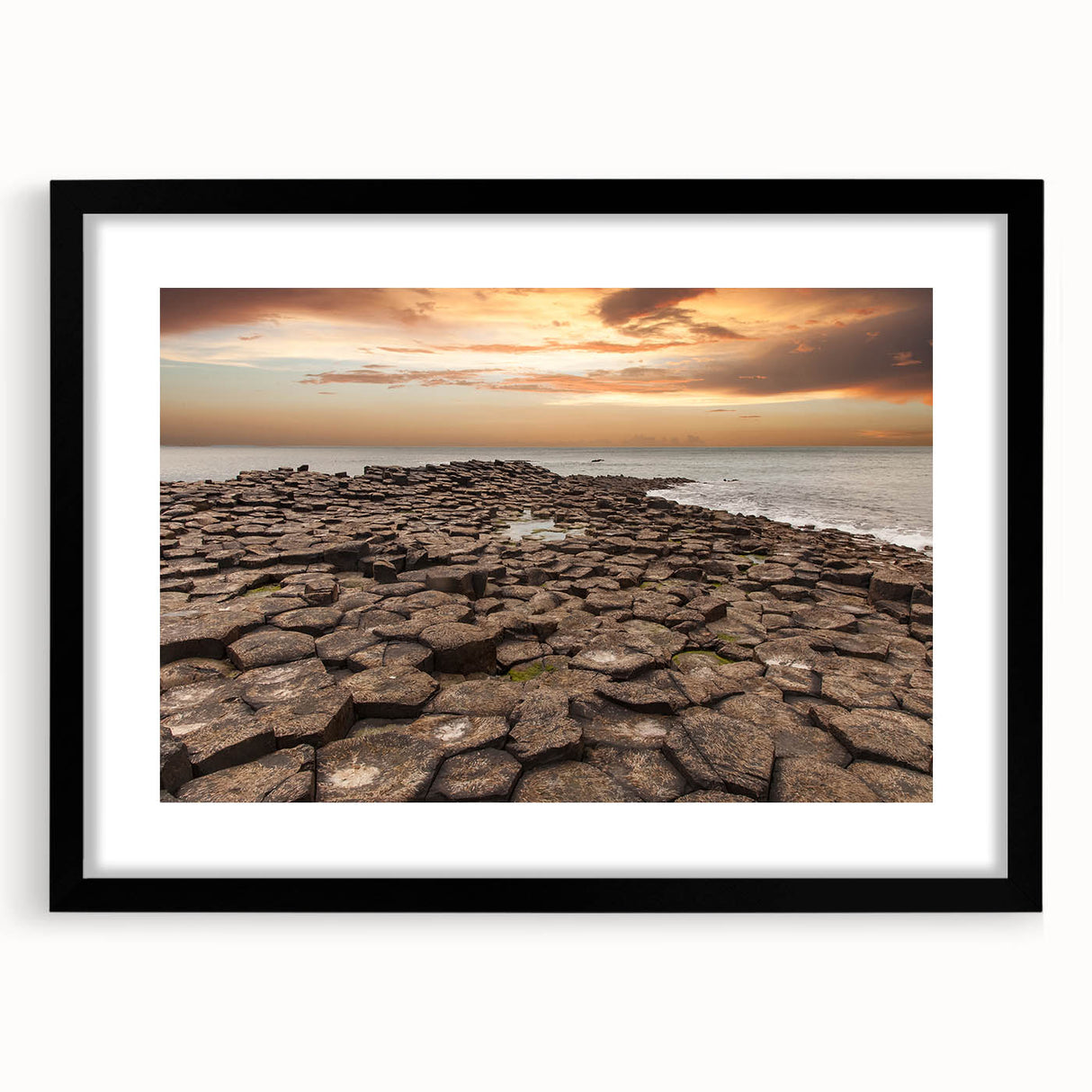 Colorful abstract art print of a textured Northern Ireland scenery in a large black frame, ideal for living room decor.