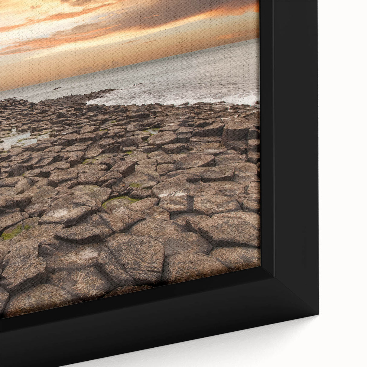 Close-up of a black framed canvas featuring a textured Northern Ireland scenery in colorful art style.