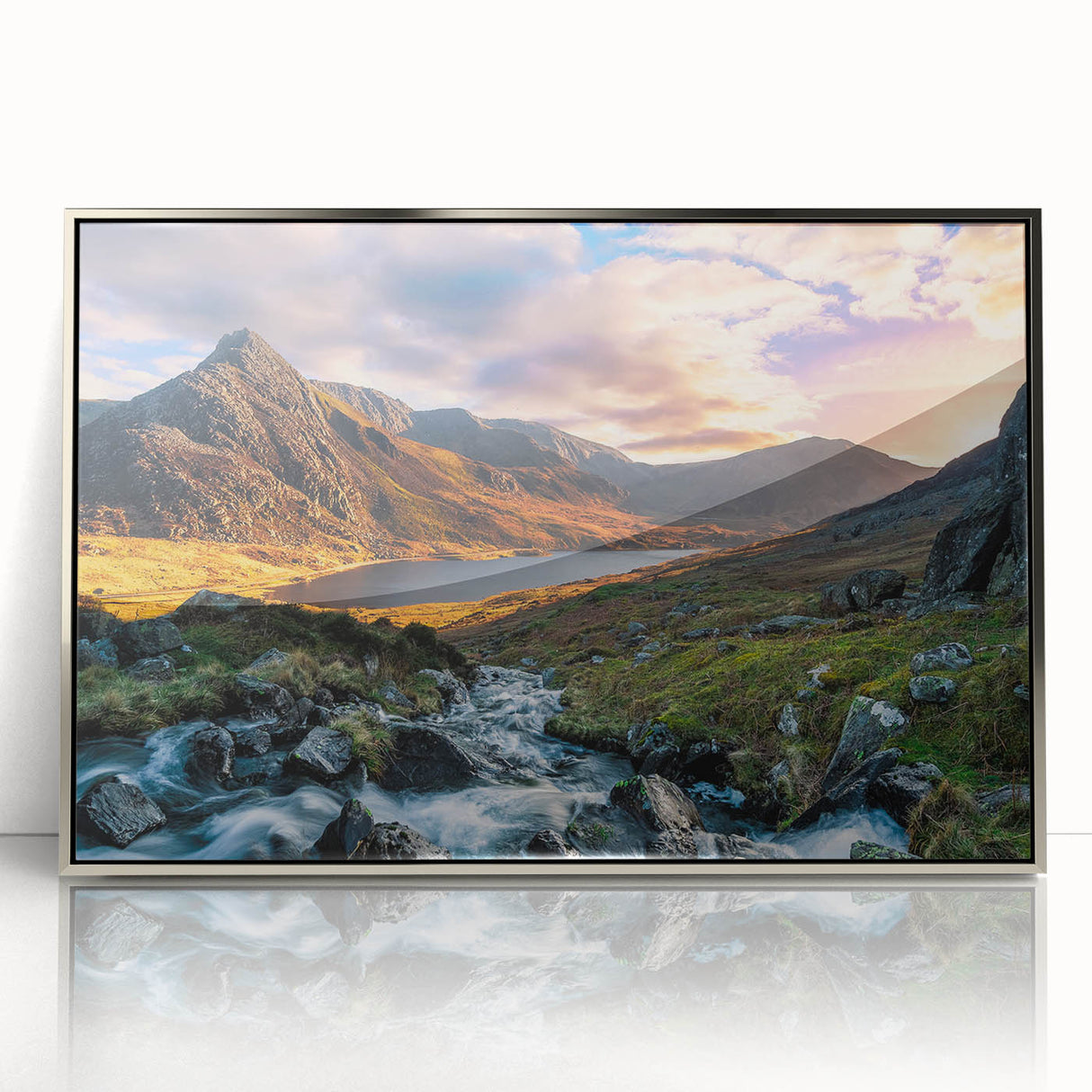 Mid-century modernist art depicting a serene Welsh landscape in muted earth tones on a silver-framed acrylic print.