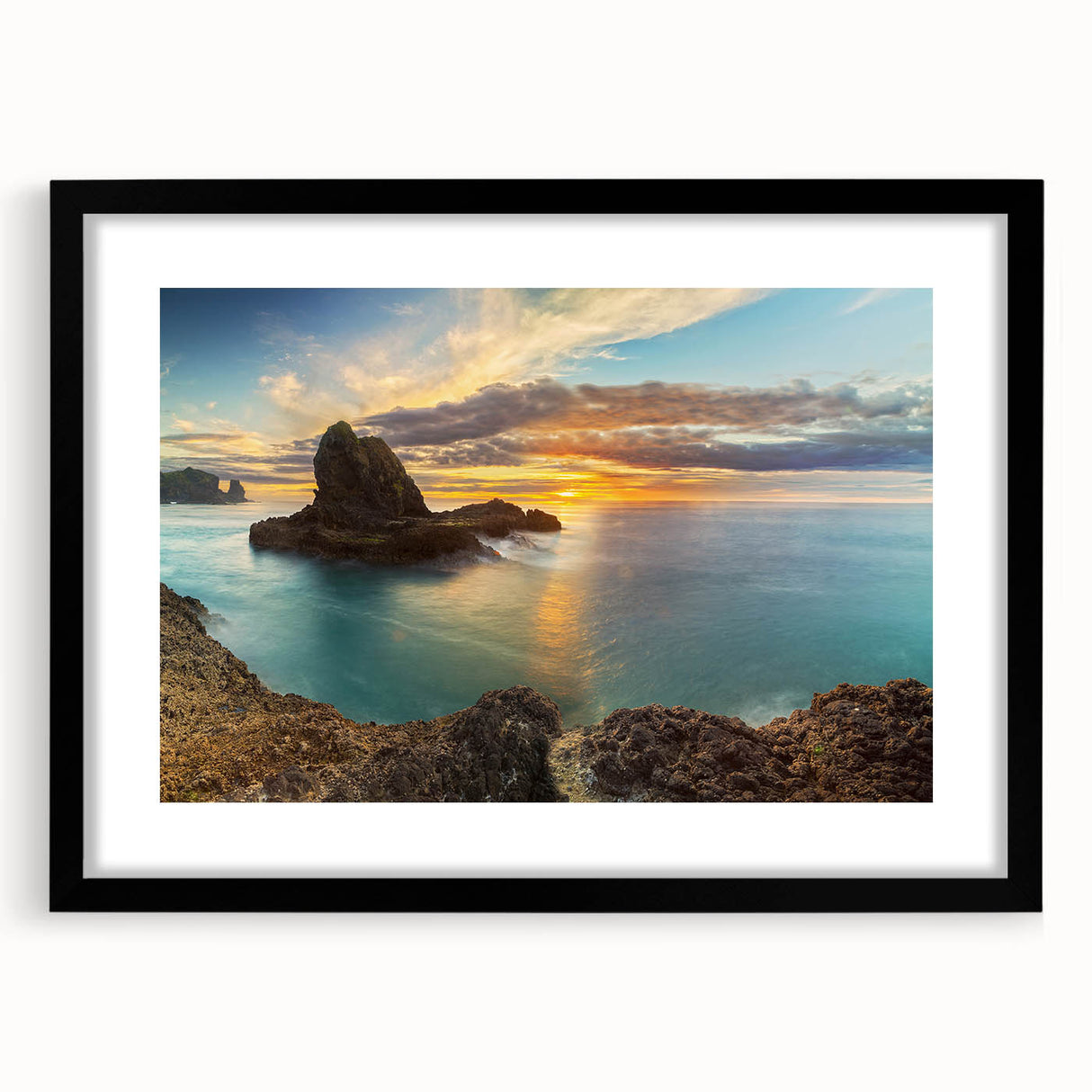 Abstract art print of New Zealand's West Coast in vibrant colors on a large textured canvas, framed in black.