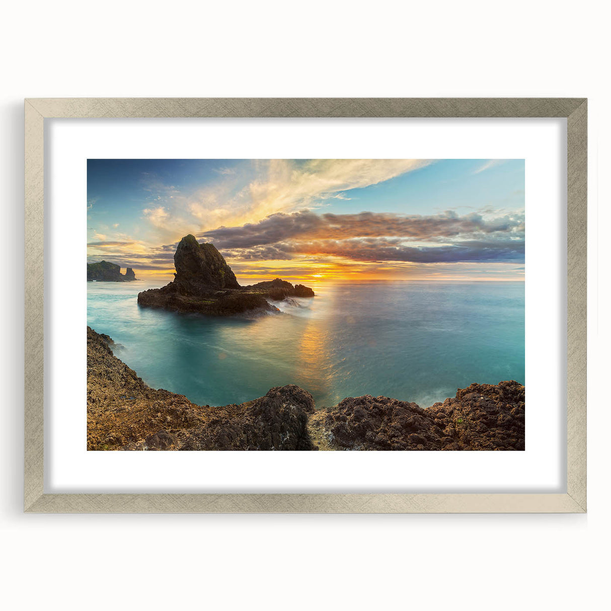 Textured art print depicting an abstract oceanic scene in muted blue and gray tones on a silver-framed canvas.