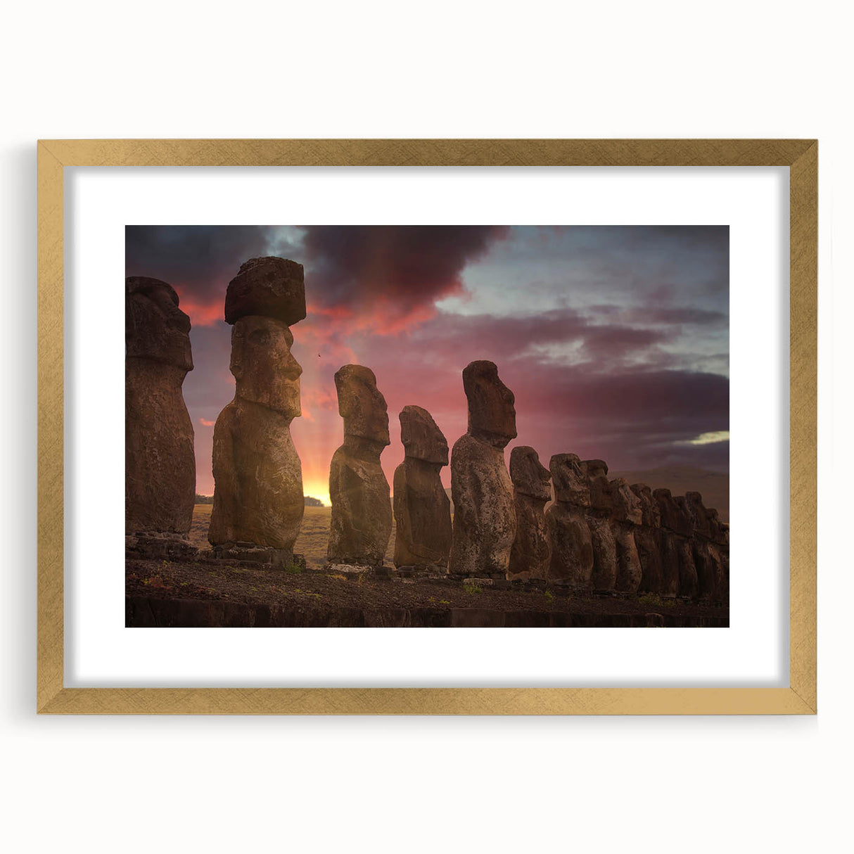Extra large wall art featuring an abstract depiction of Easter Island heads in textured earth tones, framed in gold.