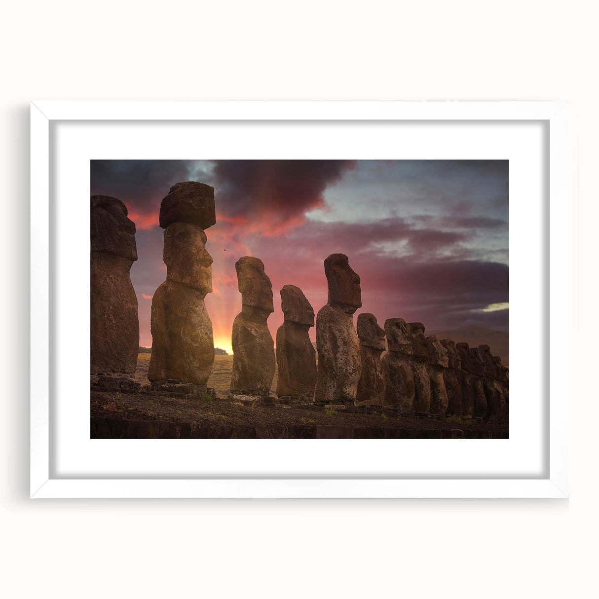 Abstract art print of Easter Island statues in muted earth tones on a framed white mat.