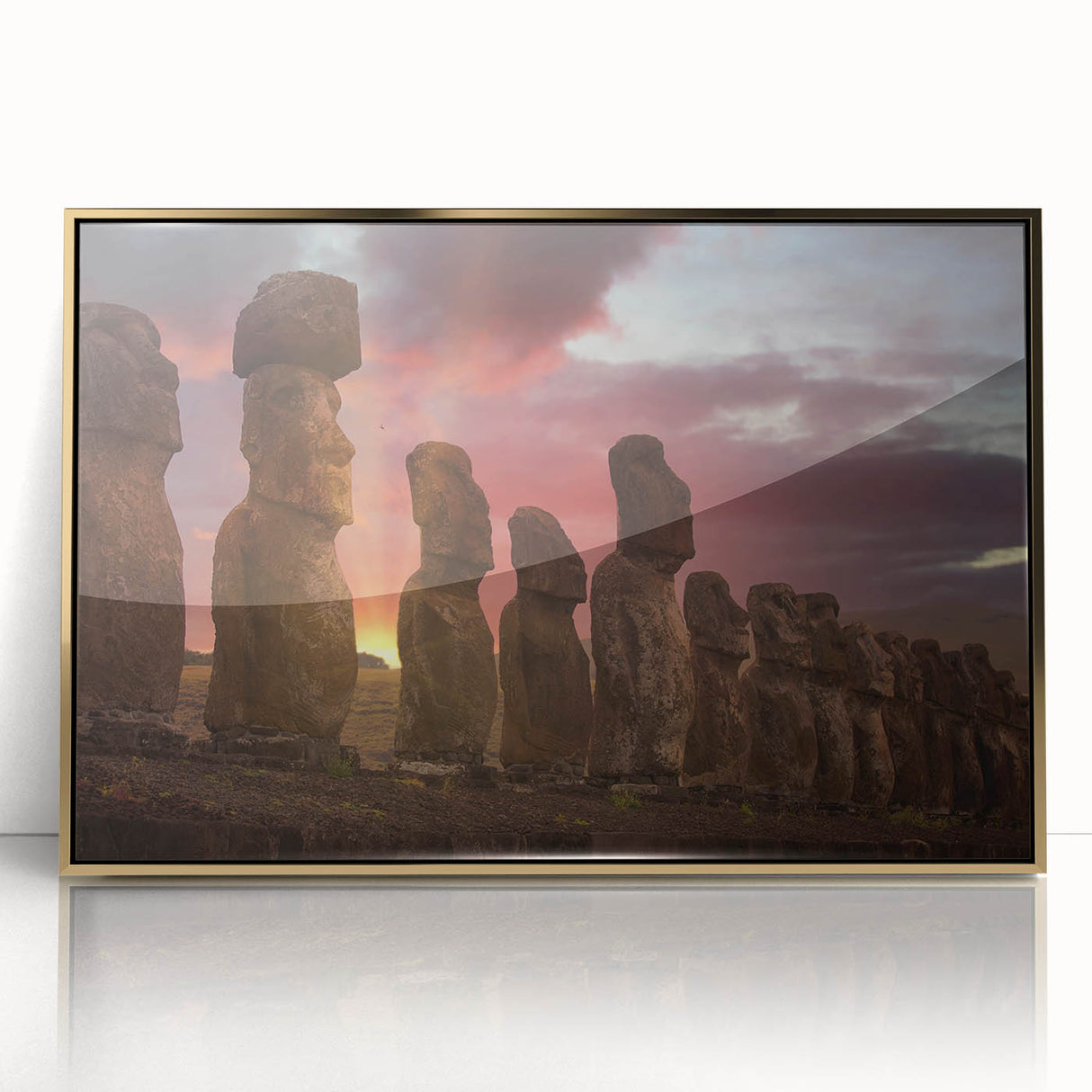 Acrylic print of Easter Island statues in earth tones, framed in gold, suitable for modern art wall decor.