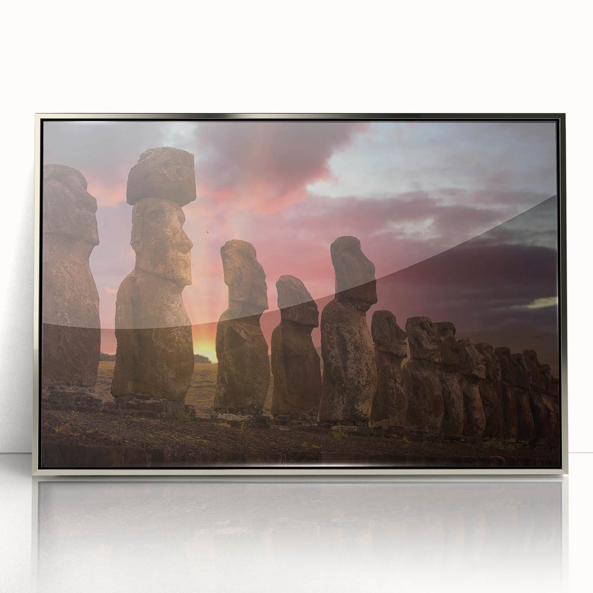 Mid-century modernist art of Easter Island statues in muted earth tones on a silver-framed acrylic print.