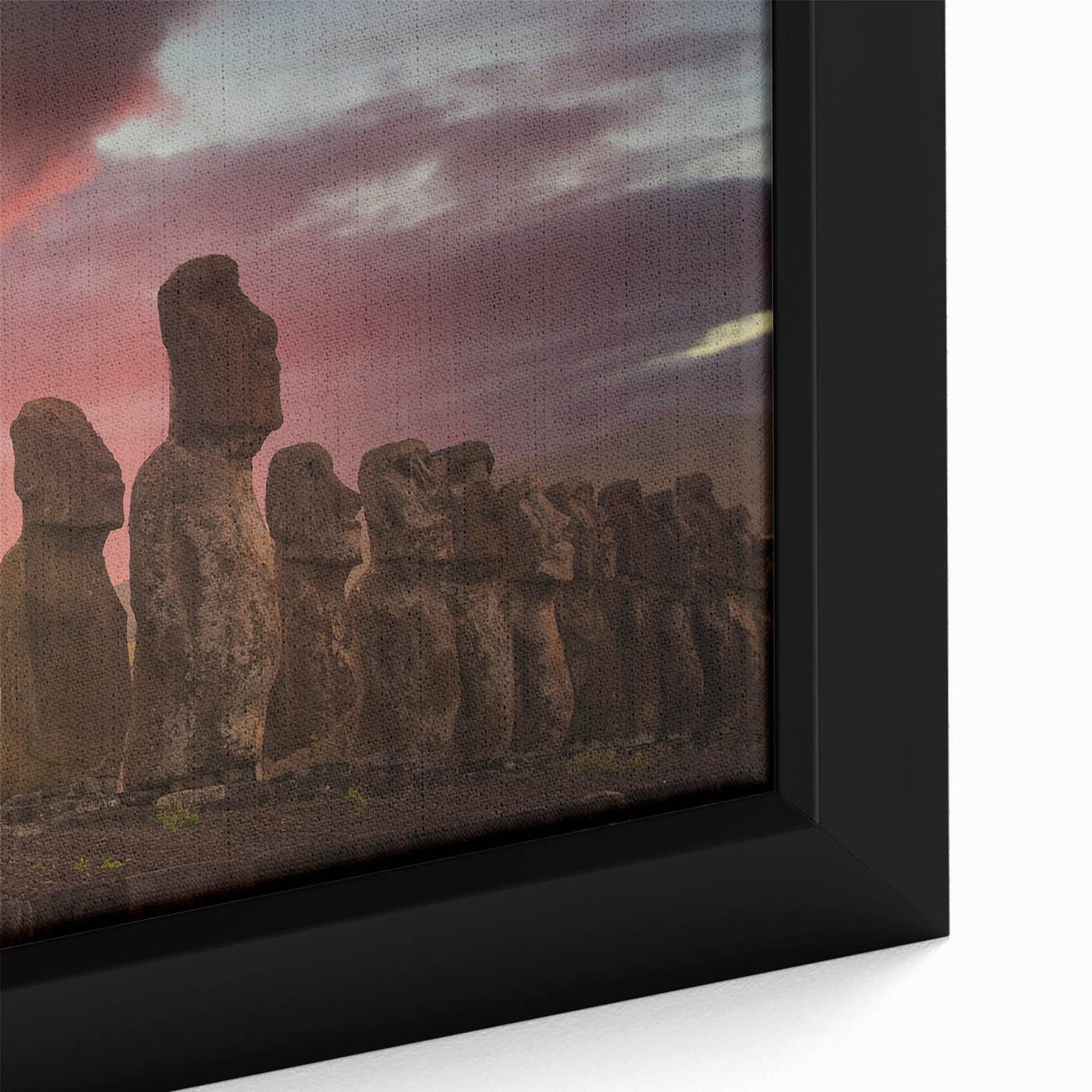 Framed canvas depicting Easter Island statues in black, with a textured, colorful background, suitable for living room decor.