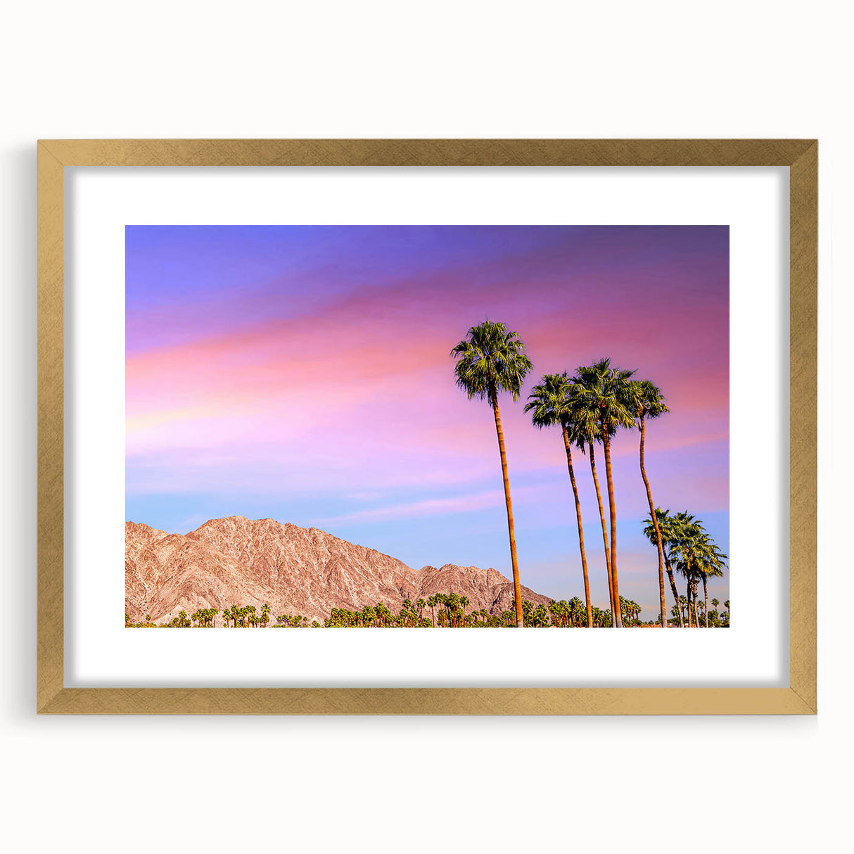 Extra large abstract art print of Palm Springs with textured palm tree silhouettes in muted earth tones, framed in gold.