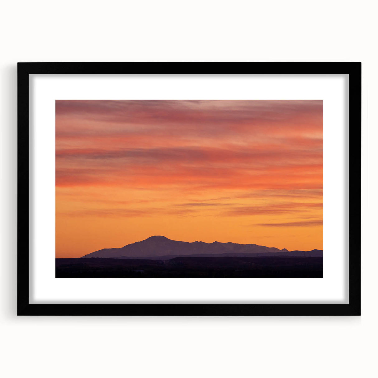 Colorful abstract art print of Pikes Peak with vibrant textures on a large framed canvas, ideal for living room decor.