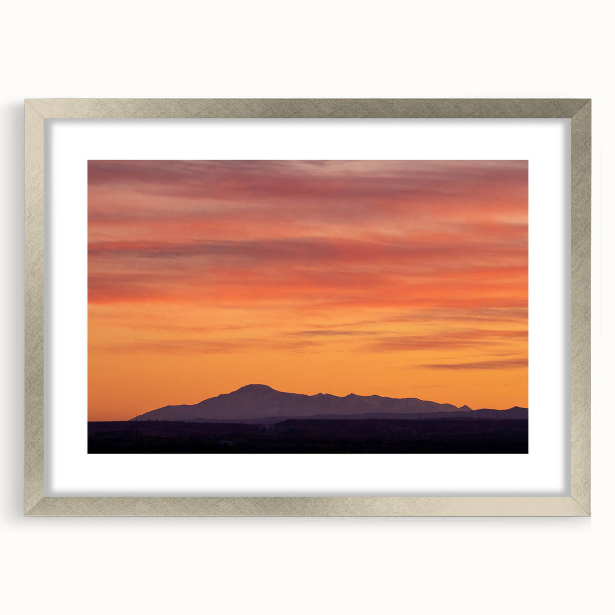 Textured art depicting Pikes Peak in abstract style, with muted earth tones on a framed silver mat, ideal for bedroom art.