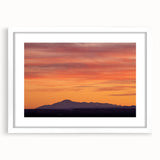 Abstract art print of Pikes Peak in muted blue and green tones, framed with a white mat, ideal for dining room decor.