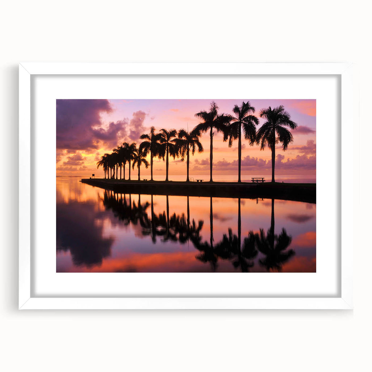 Abstract art print of Miami skyline in muted blue and pink tones on a white framed poster.