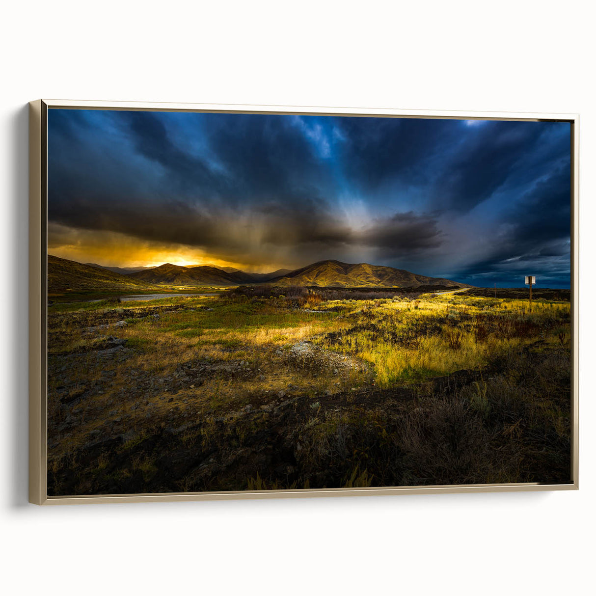 Framed canvas featuring a vintage-style landscape painting of Idaho scenery, with muted gold and black tones.