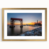 Extra large abstract art print of Baltimore skyline, featuring textured gold and blue hues on a framed canvas.