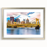 Textured art print of abstract Pittsburgh skyline in muted gray and blue tones on a framed silver mat.