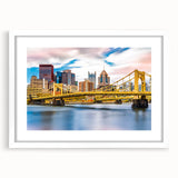 Abstract art print of Pittsburgh skyline in muted gray and blue tones on a framed white mat, suitable for dining room decor.
