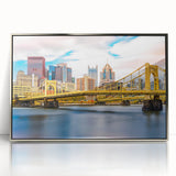 Mid-century modernist art depicting the Pittsburgh skyline in muted gray and blue tones on a framed acrylic print.
