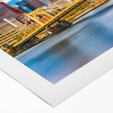 Art deco poster of Pittsburgh skyline in muted gold and blue tones on rolled canvas, suitable for dining room wall art.