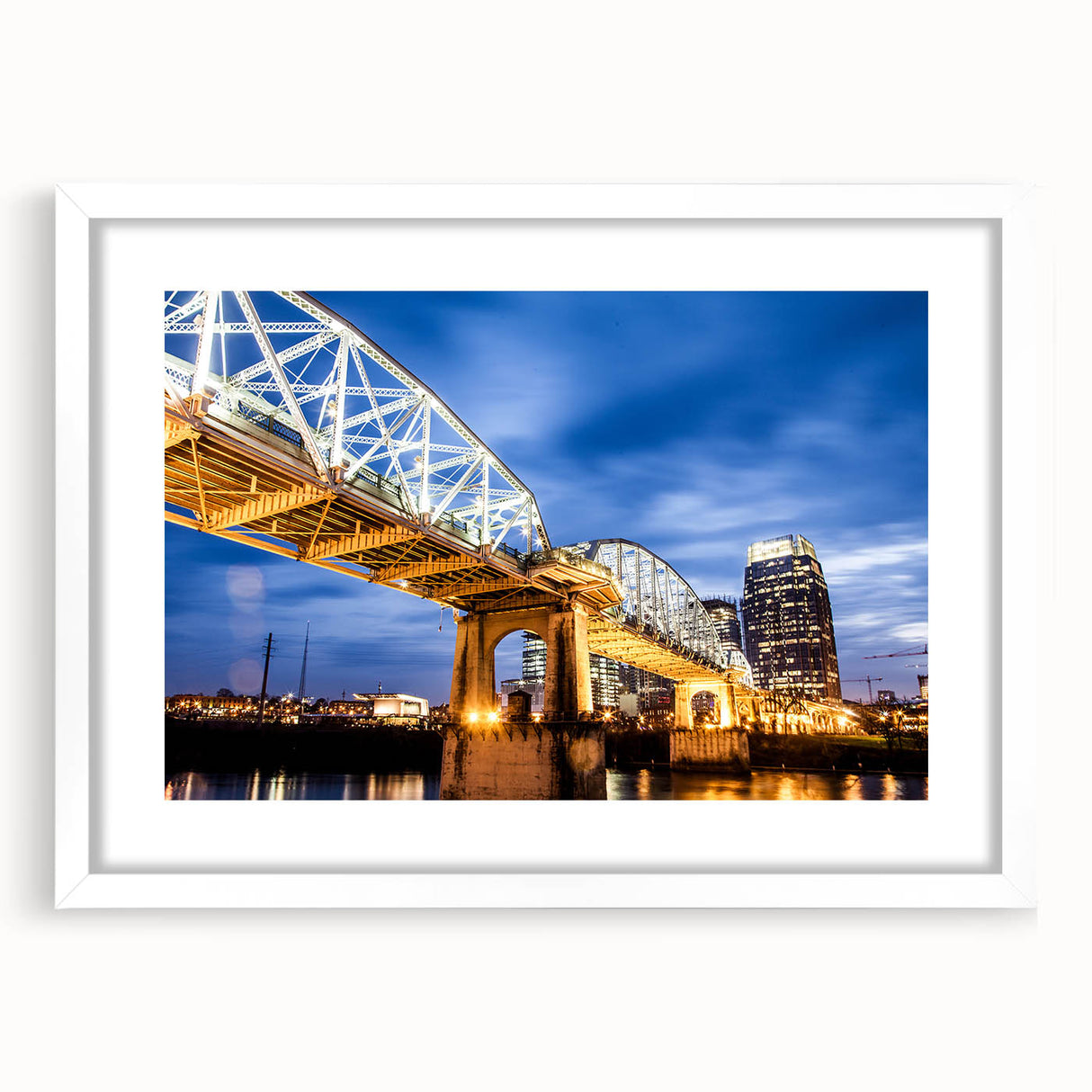 Abstract art print of Nashville skyline in muted blue and gray tones on a framed white mat, suitable for dining room decor.