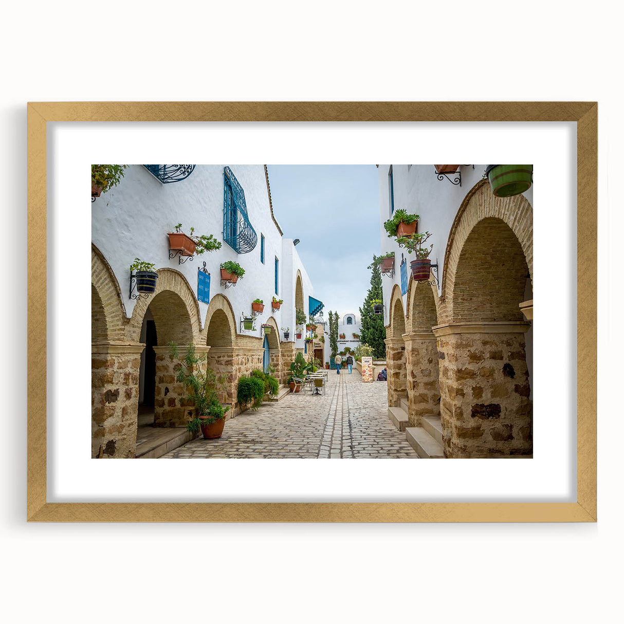 Abstract art print of a Tunisian landscape in muted earth tones, framed in gold, ideal for dining room decor.