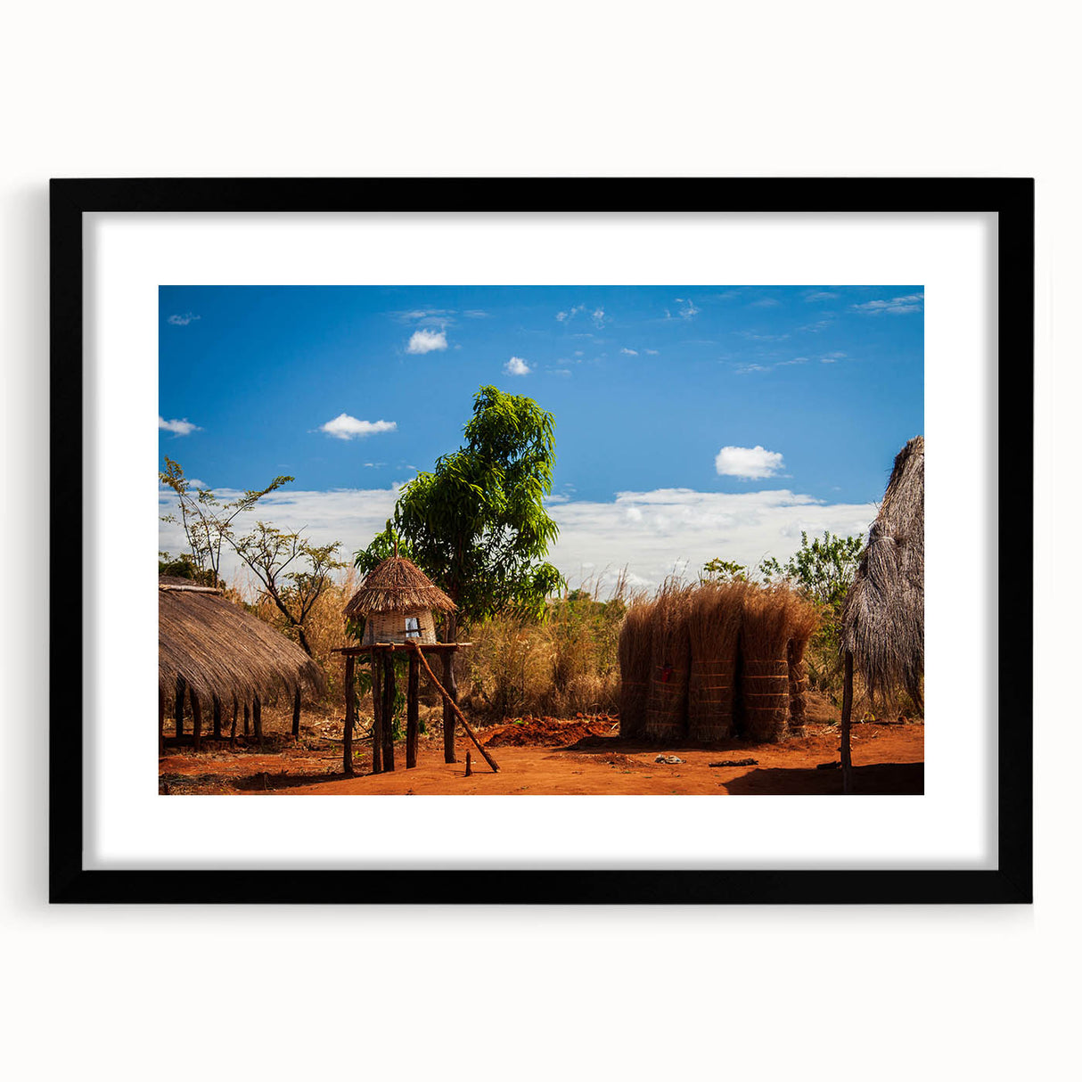 Extra large abstract art print of vibrant African scenery on textured canvas, framed in black, ideal for living room decor.