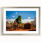 Textured abstract art print of an African scenery in muted earth tones on a framed silver mat, suitable for bedroom decor.