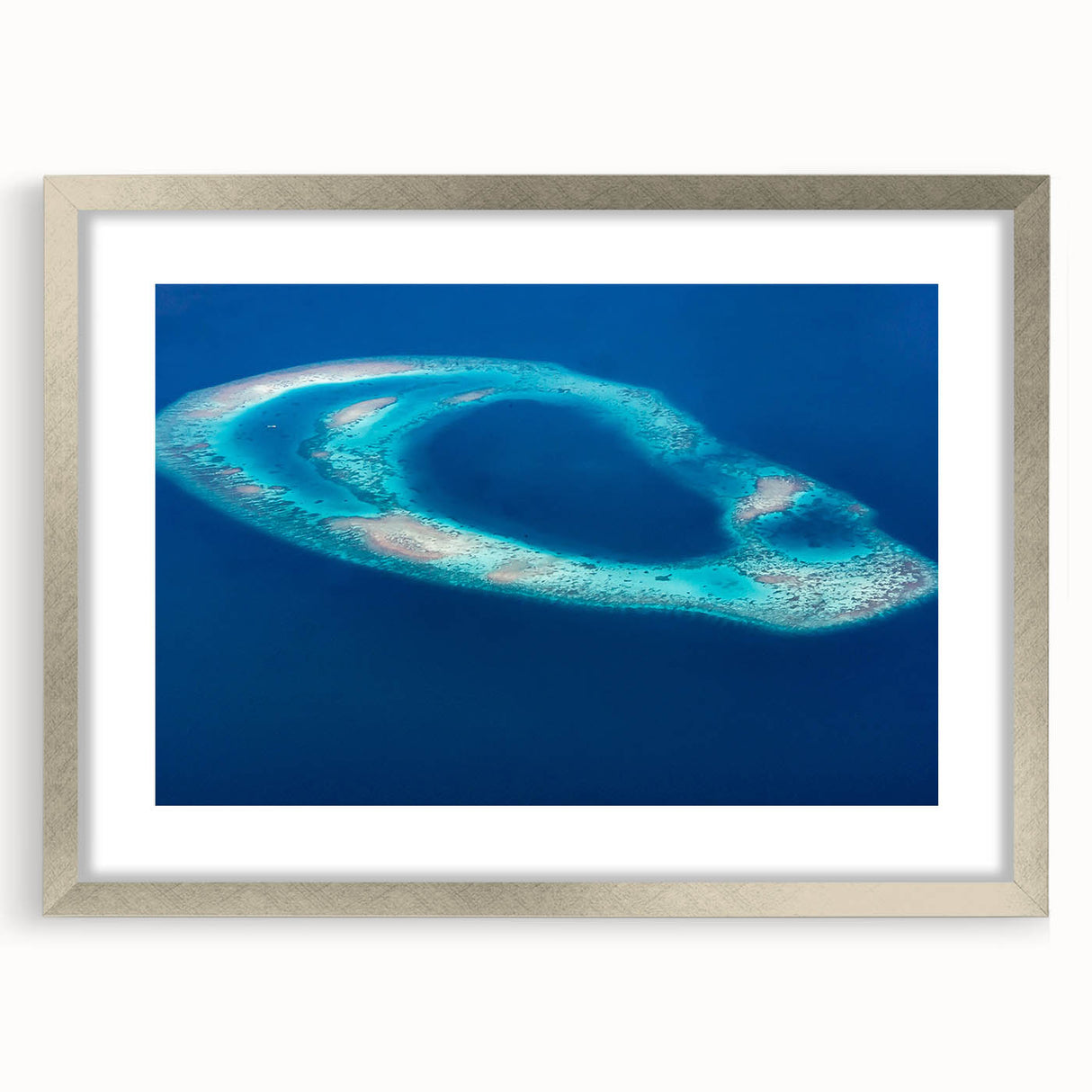 Textured art depicting an abstract Maldivian seascape in cool blue and white tones, framed in silver, ideal for bedroom art.