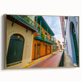 Framed canvas featuring a vintage-style landscape painting of a Central American scene in black and gold tones.