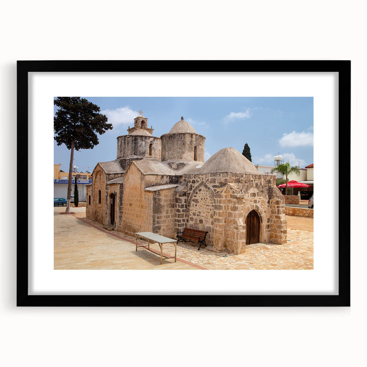 Abstract art print of a vibrant European landscape in textured colors on a large black-framed canvas.