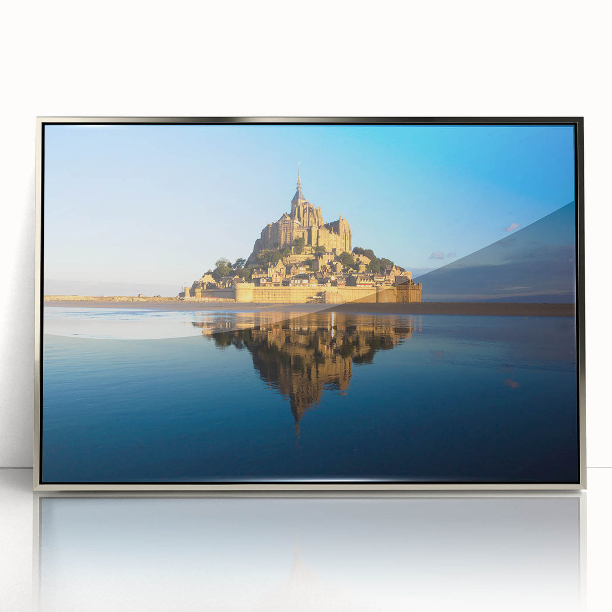 Large art print of a scenic French landscape in muted earth tones, framed in silver acrylic.
