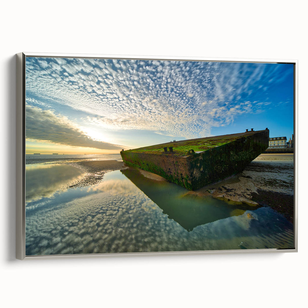 Landscape art painting of Normandy with vibrant green fields and a blue sky, framed in silver, perfect for a living room.