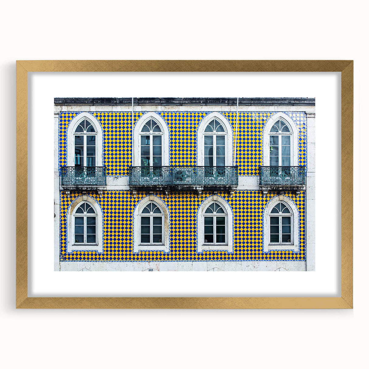 Abstract art print of Lisbon in muted gold and blue tones, framed with a gold mat, suitable for dining room decor.
