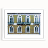 Textured abstract art print of Lisbon scenery in muted earth tones on a framed white mat, suitable for bedroom decor.