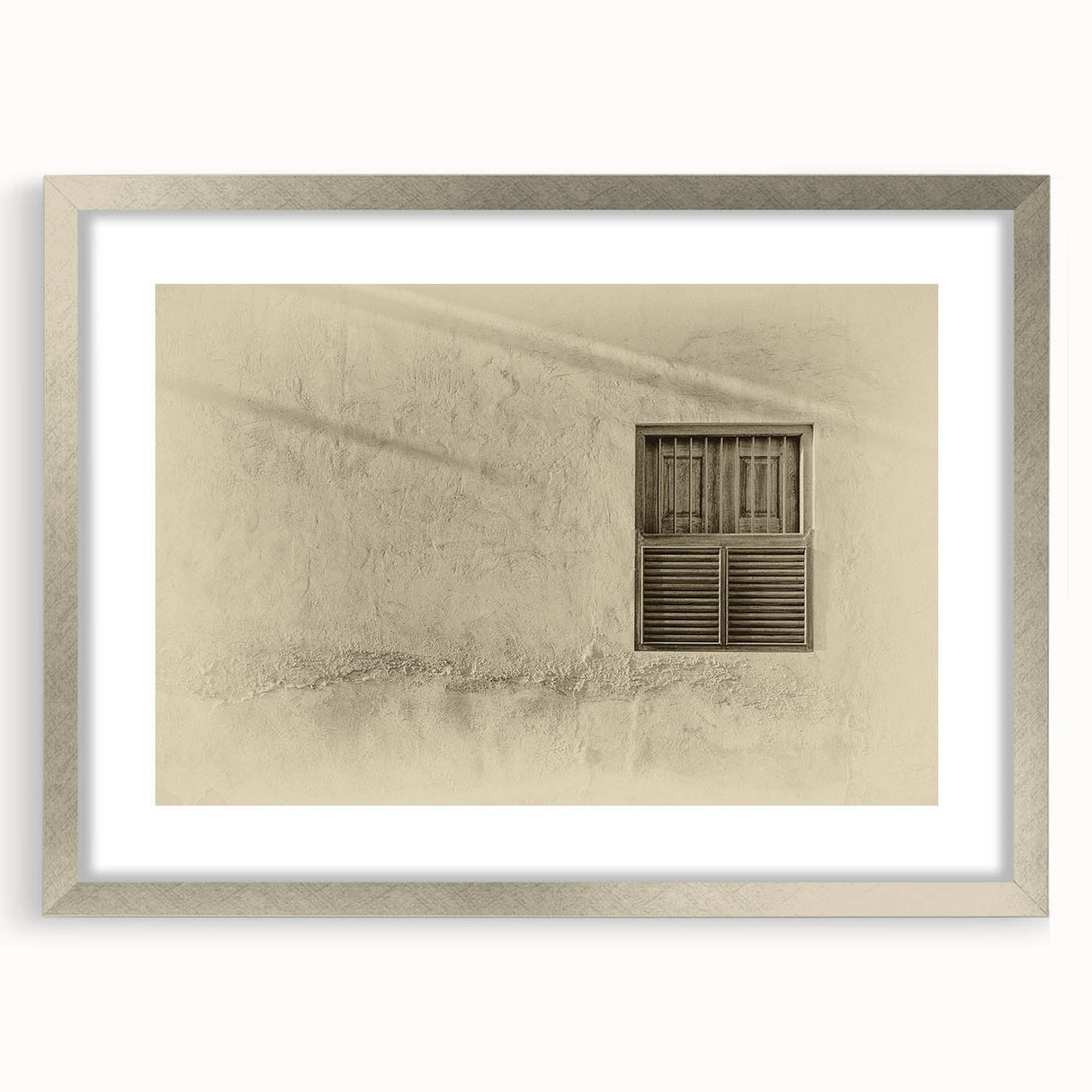 Textured abstract art print depicting a Middle Eastern scenery in muted earth tones, framed in silver, ideal for bedroom art.