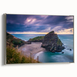Vintage poster art of New Zealand's west coast in a silver frame, featuring vibrant coastal colors.