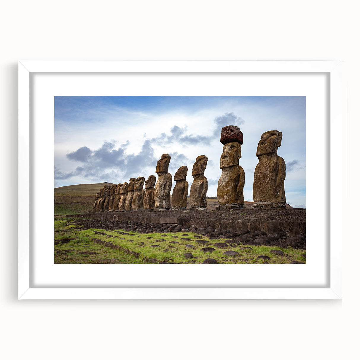 Abstract art print of Easter Island statues in muted earth tones on a framed white mat.