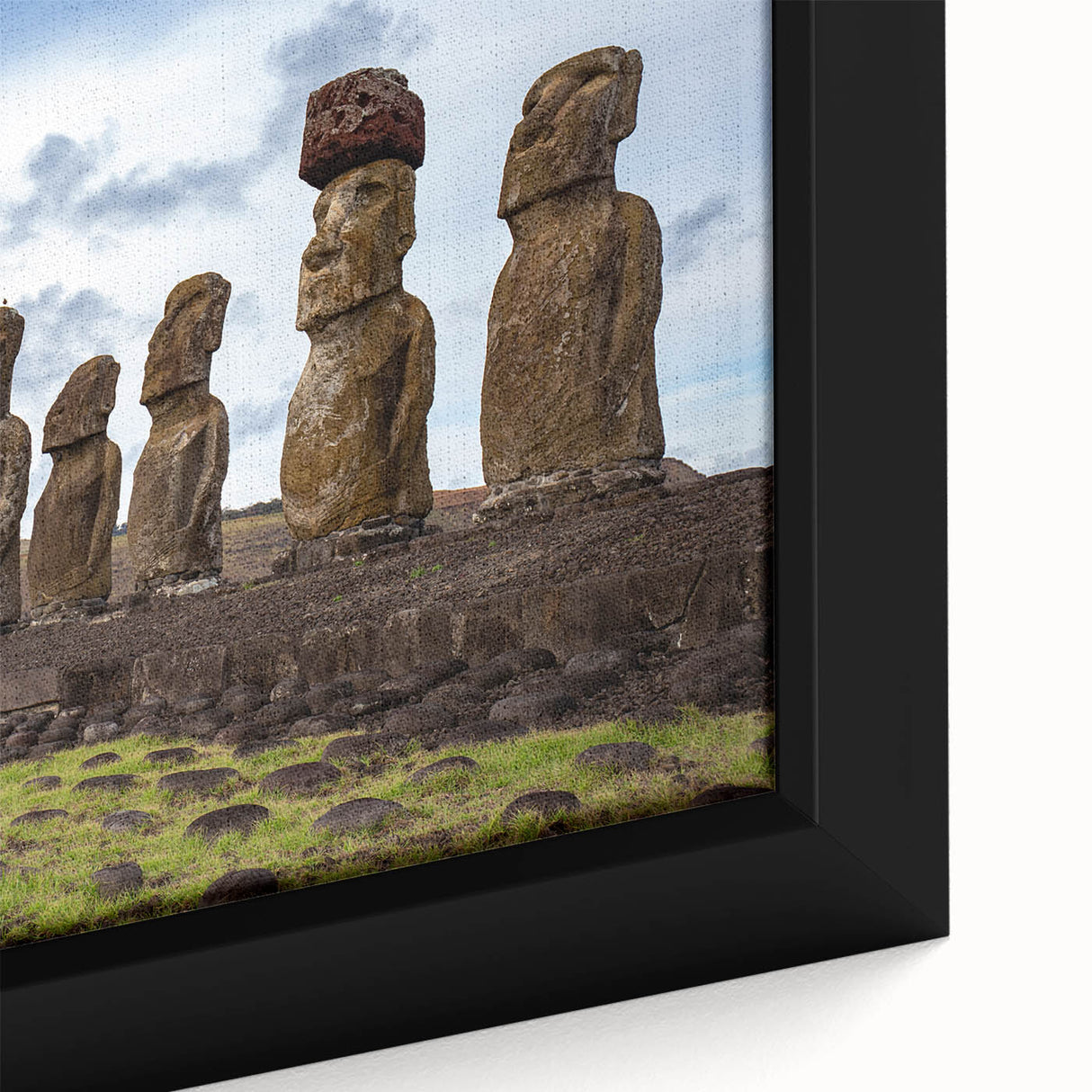 Close-up of a black framed canvas featuring a textured depiction of Easter Island statues in vibrant, colorful art.