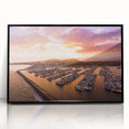 Large abstract wall art depicting the Santa Barbara coast in muted blue and green tones on a black framed acrylic print.