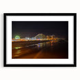 Abstract art print depicting colorful, textured scenery, framed in black, ideal for living room decor.