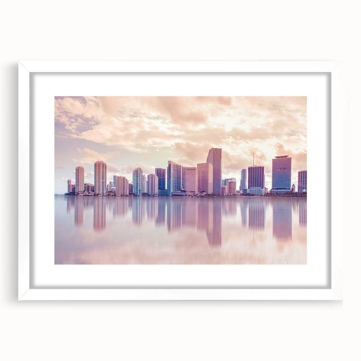 Abstract art print of Miami skyline in muted blue and pink tones on a framed white mat, ideal for dining room decor.